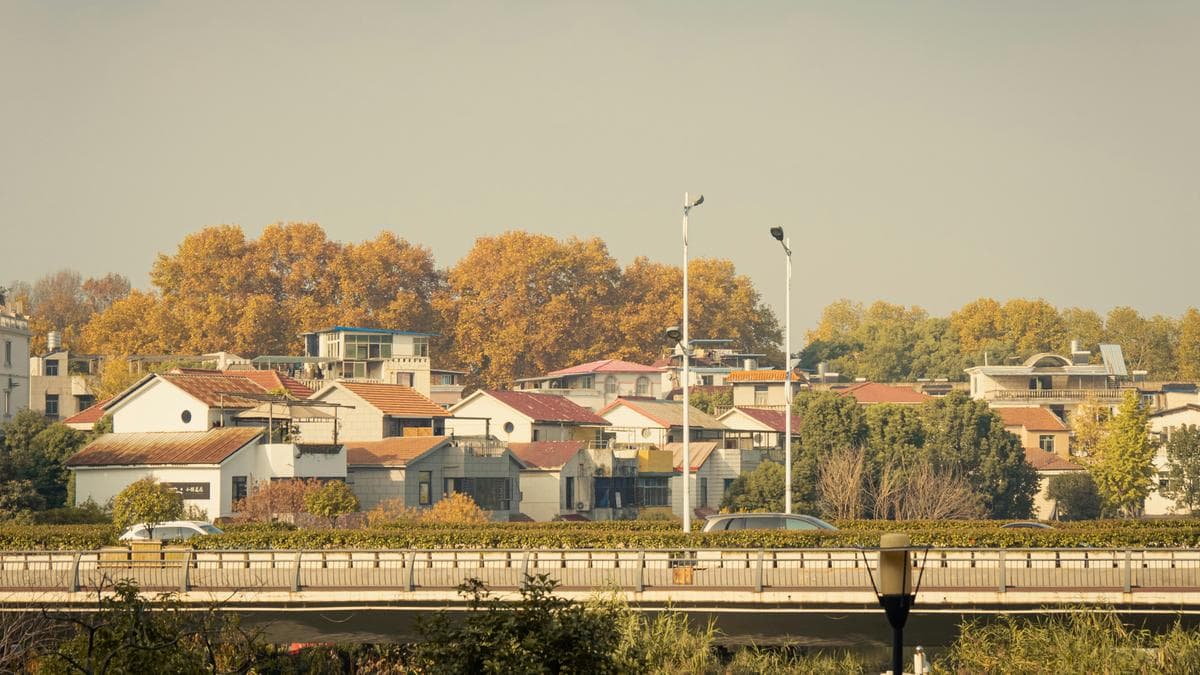 A bridge over a river with houses in the background — communities Neoulo serves